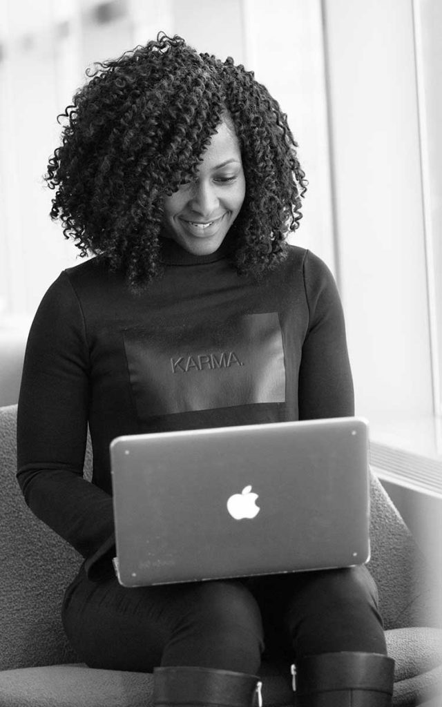 Smilling woman using a macbook PC